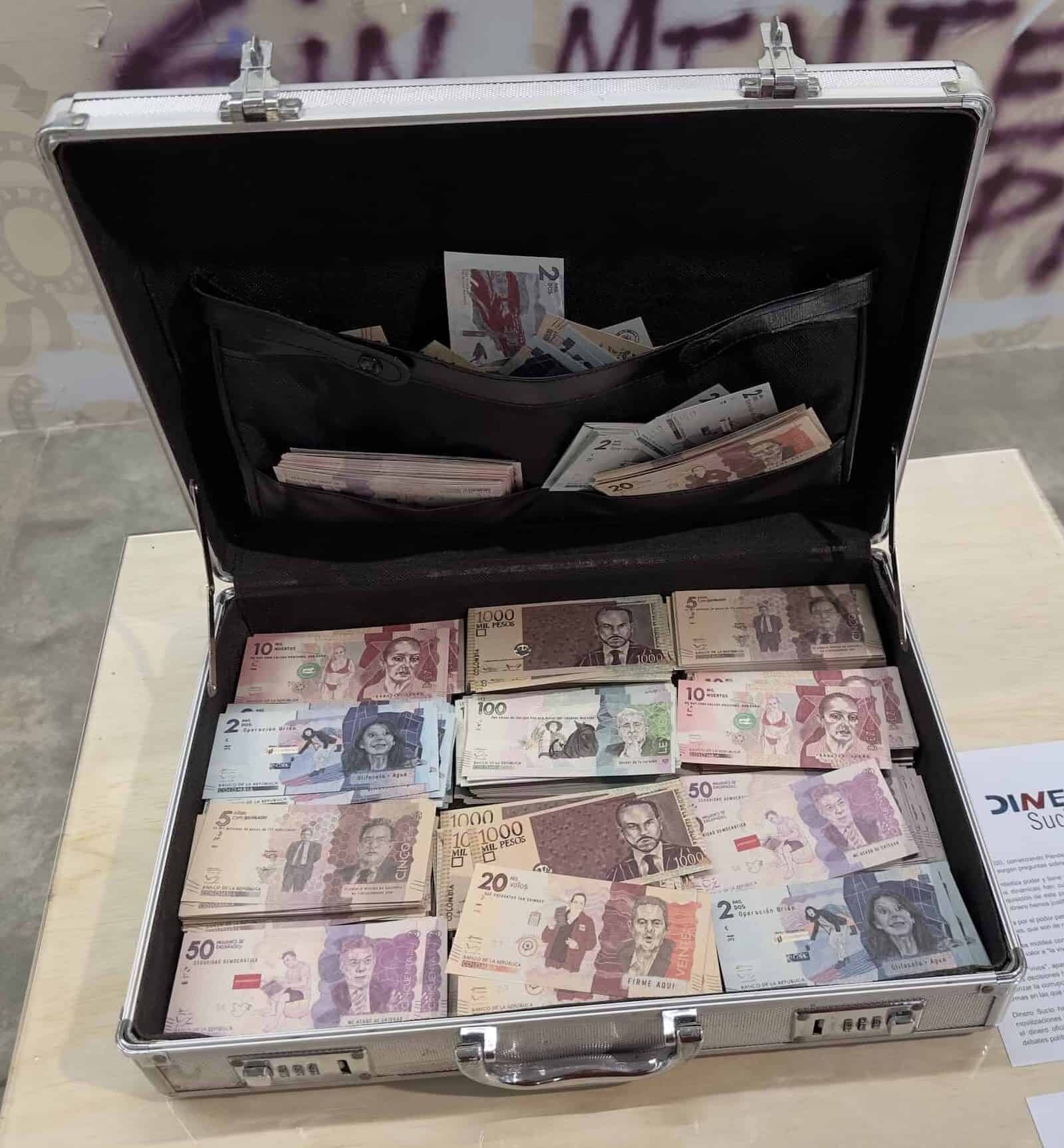 Briefcase full of "dirty money" with the faces of Colombian politicians in S.O.S. Medellín in Medellín, Pulse of the City at the Medellín Museum of Modern Art in Medellín, Antioquia, Colombia