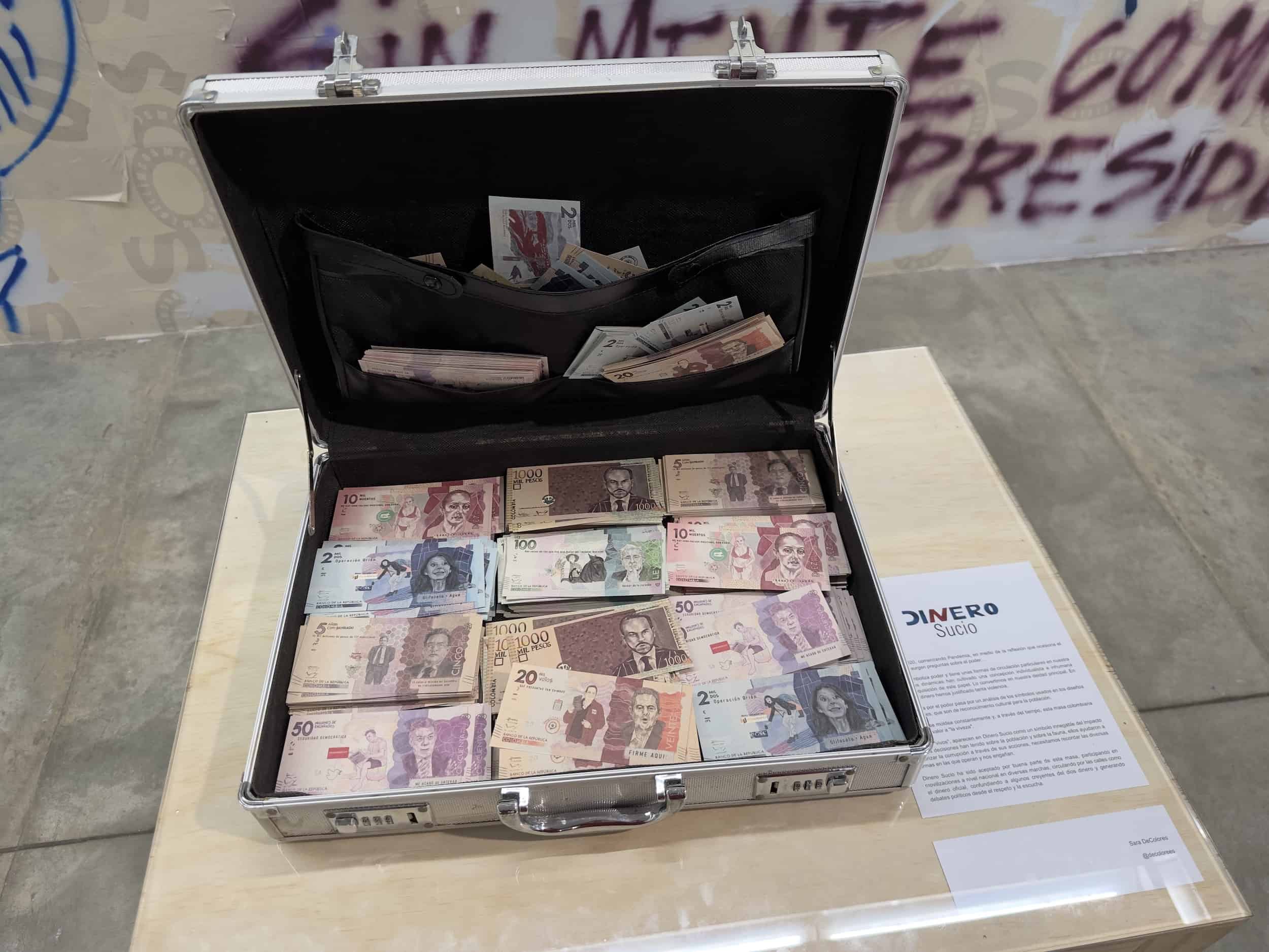 Briefcase full of "dirty money" with the faces of Colombian politicians in S.O.S. Medellín in Medellín, Pulse of the City at the Medellín Museum of Modern Art in Medellín, Antioquia, Colombia
