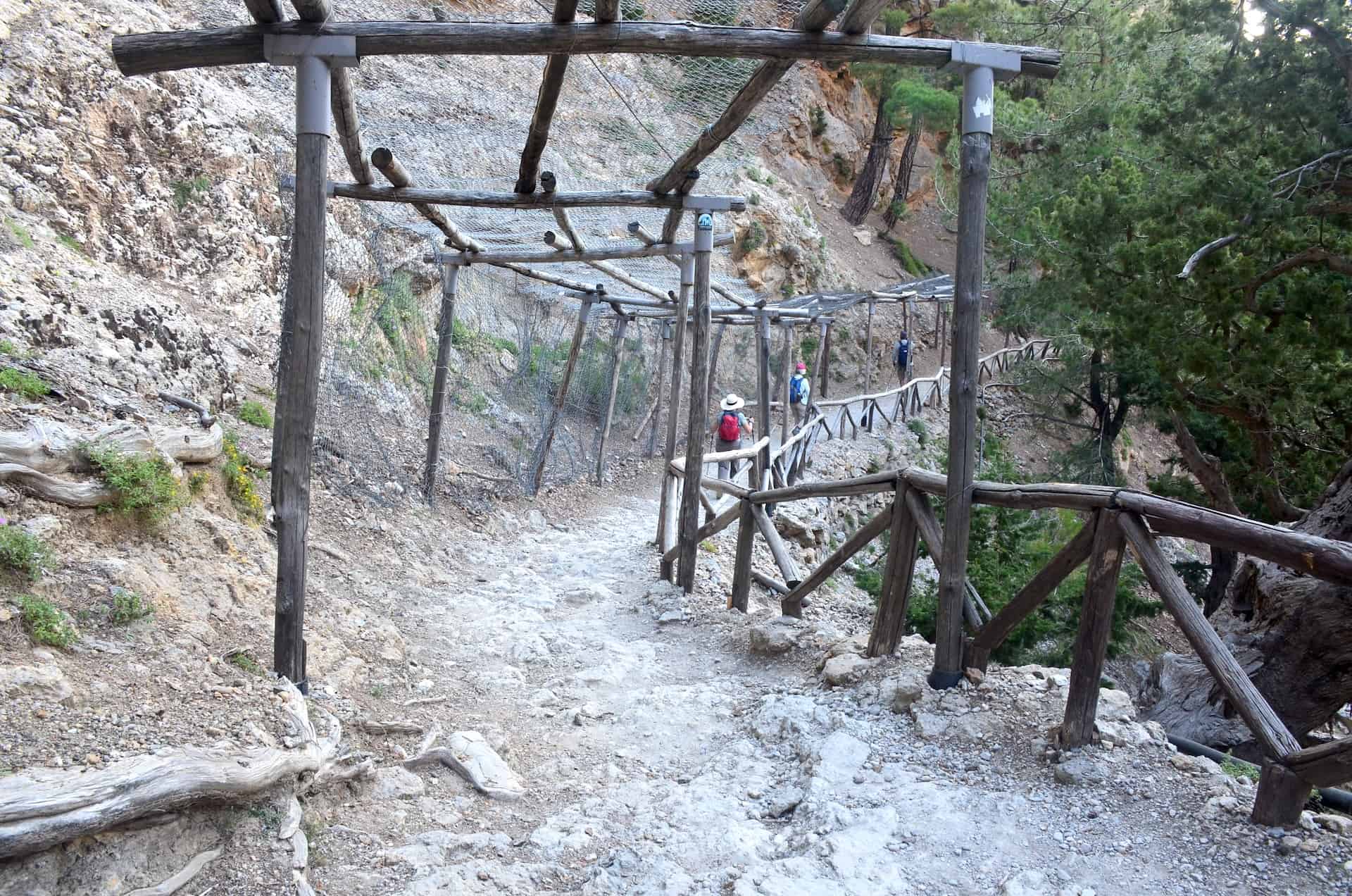 Walking under a canopy built to protect from falling rocks at Xyloskalo at the Samaria Gorge in Crete, Greece
