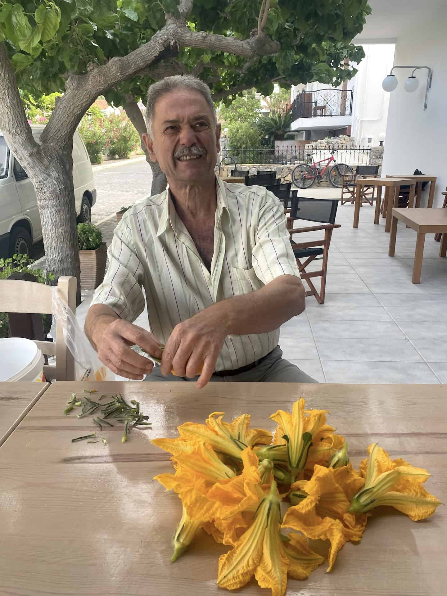 The owner preparing zucchini flowers for dinner at Hotel Calypso at Agia Roumeli, Crete, Greece