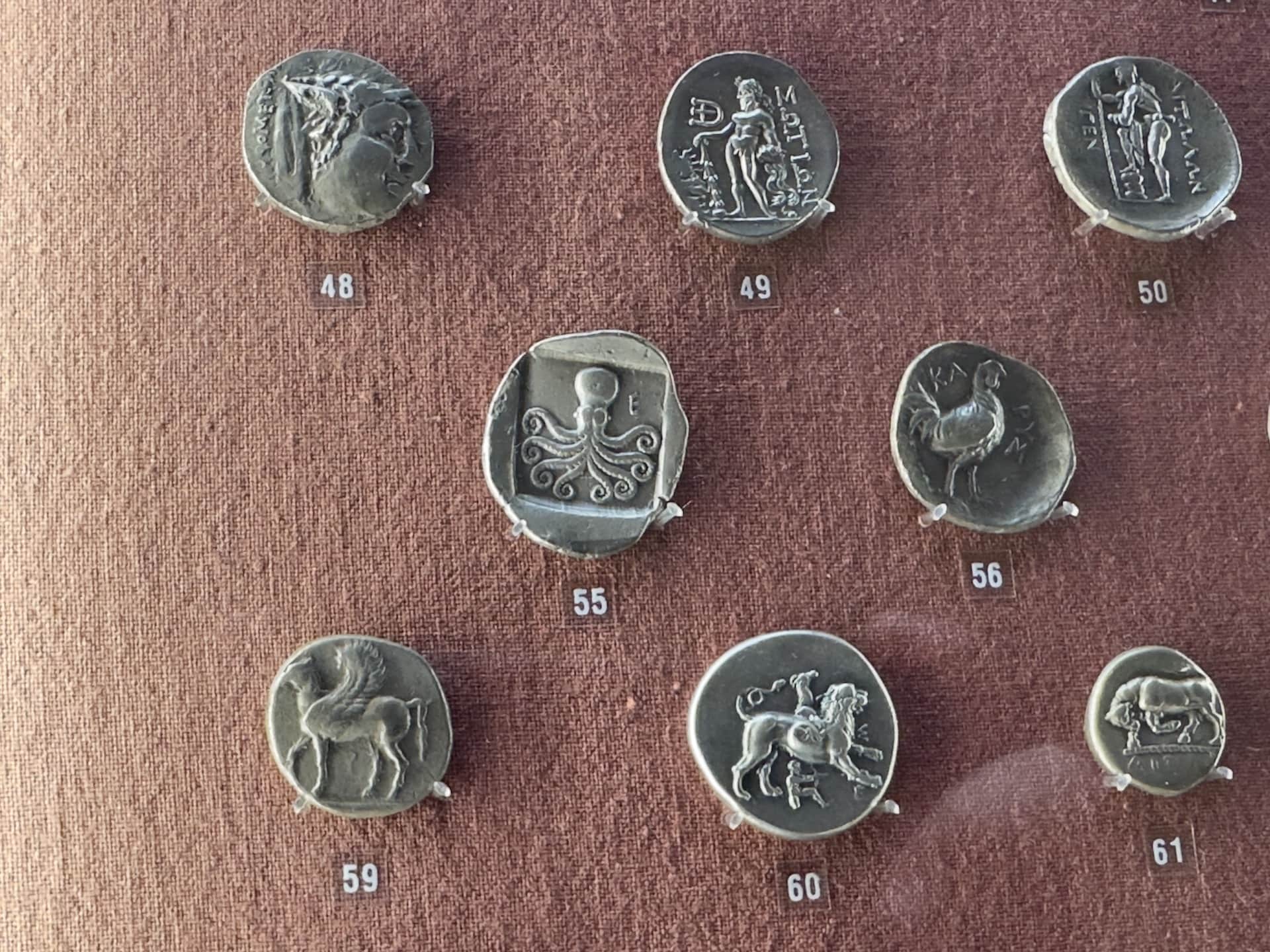 Coins featuring animals including an octopus at the Numismatic Museum in Athens, Greece