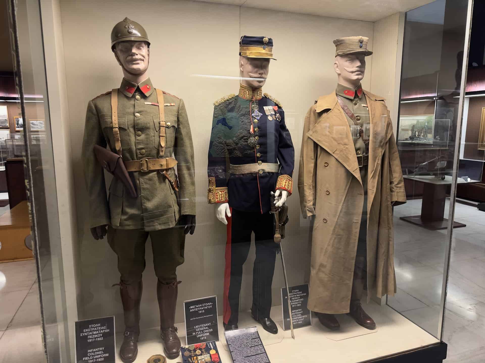 Infantry colonel field uniform, 1917-1922, (left); Lieutenant general in full dress uniform, 1915 (center); Infantry lieutenant colonel field uniform with trench coat, 1917-1922 (right) at the War Museum in Athens, Greece