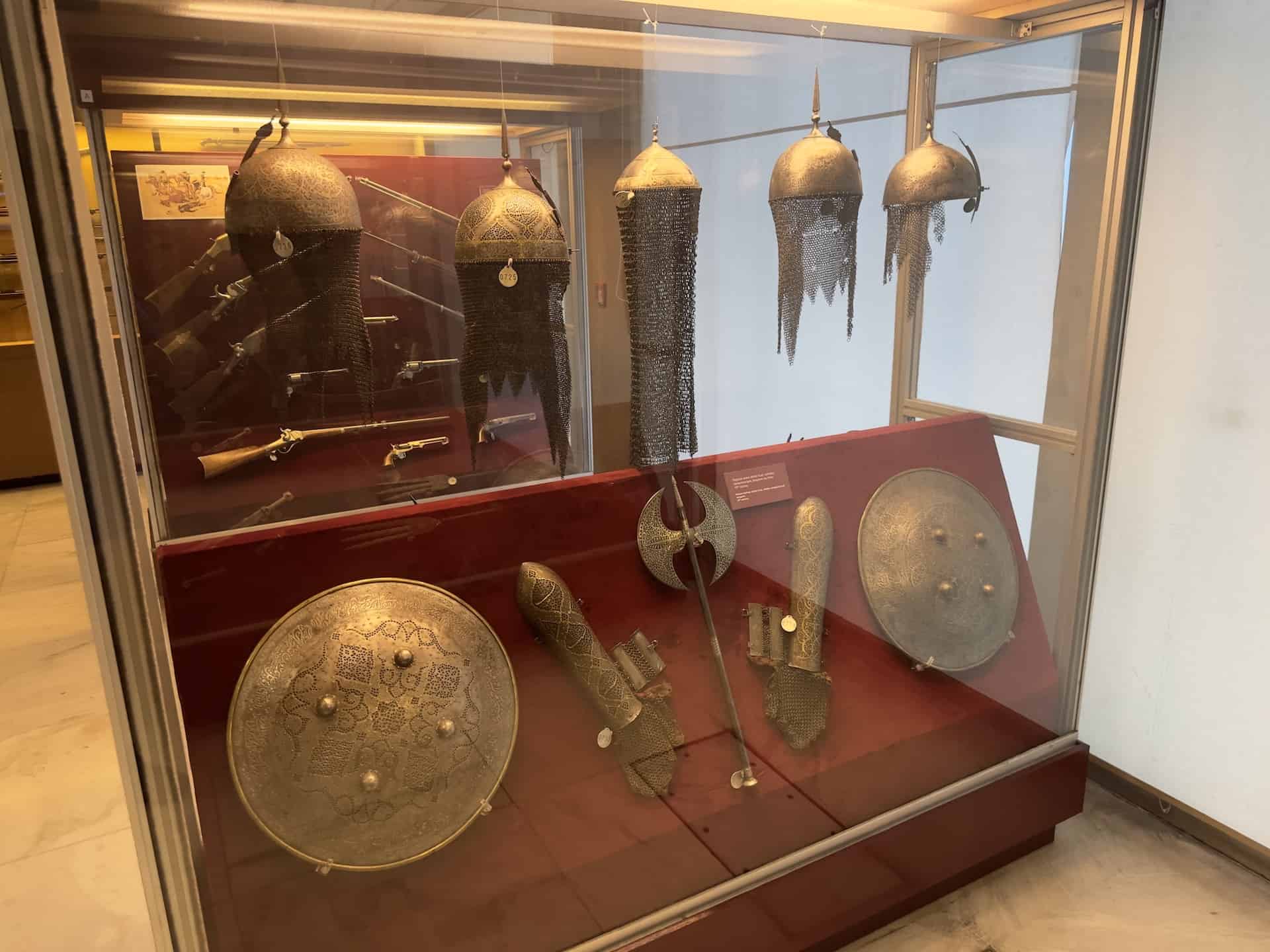 Persian helmets, shields, armguards, and weapons; 19th century in the weapons gallery at the War Museum in Athens, Greece