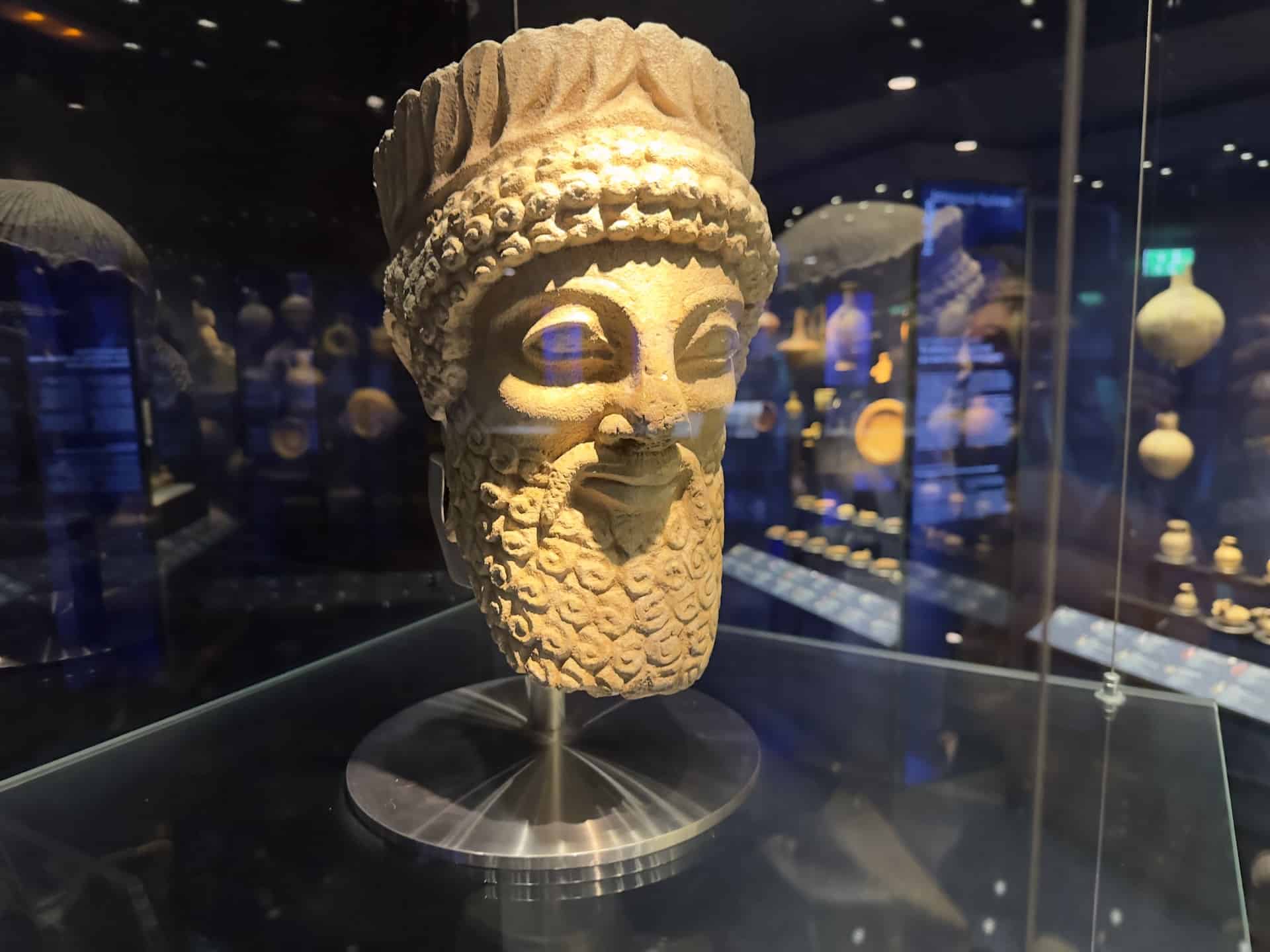Bearded male head wearing a wreath of oak leaves; limestone; Cypro-Classical (480-400 BC) in Cypriot Culture at the Museum of Cycladic Art in Athens, Greece