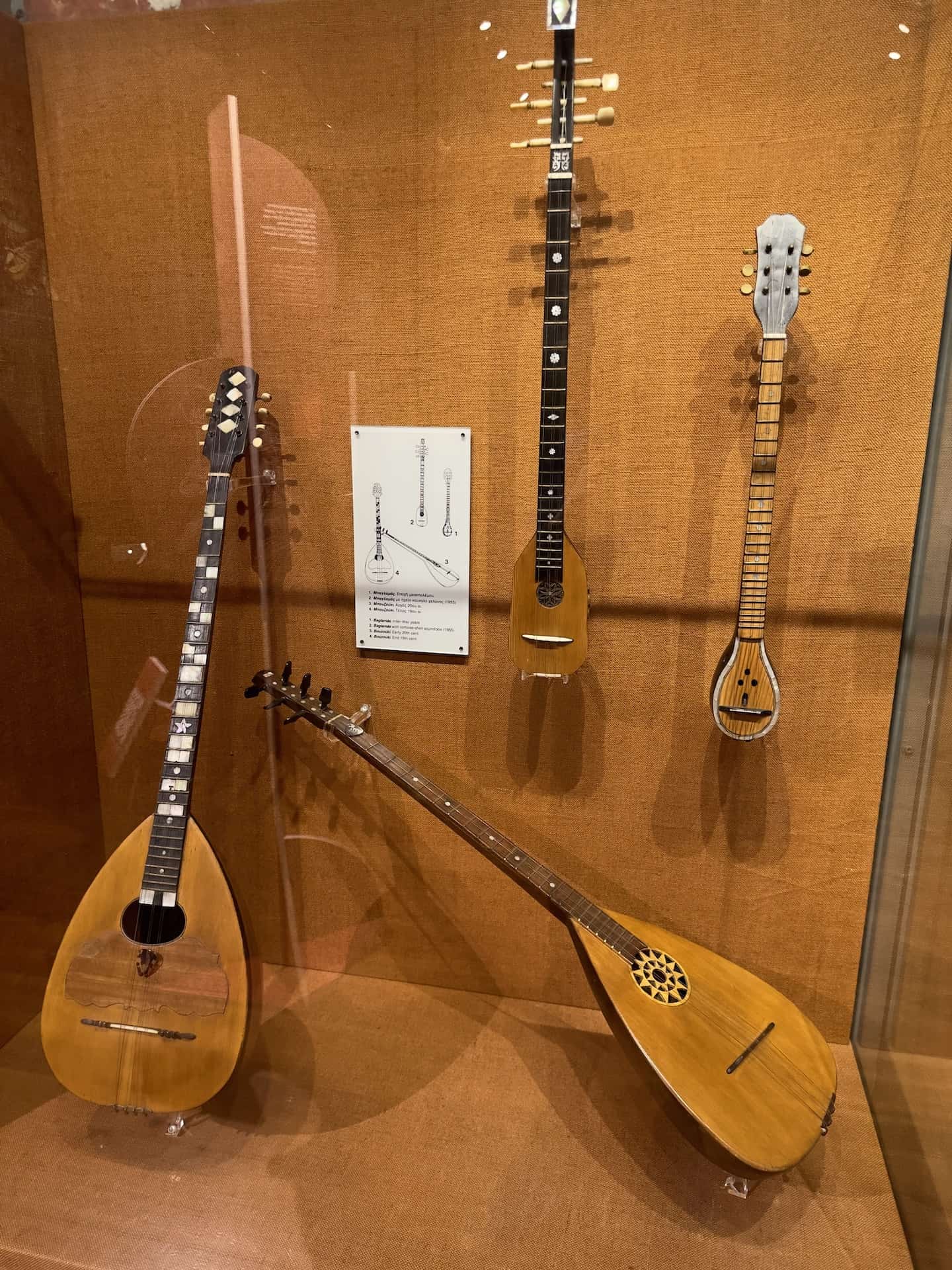 Baglamás with tortoise-shell sound box, 1955 (top center); Baglamás, inter-war years (upper right); Bouzoúki, late 19th century (lower left); Bouzoúki, early 20th century (lower right) at the Museum of Greek Folk Musical Instruments in Athens, Greece