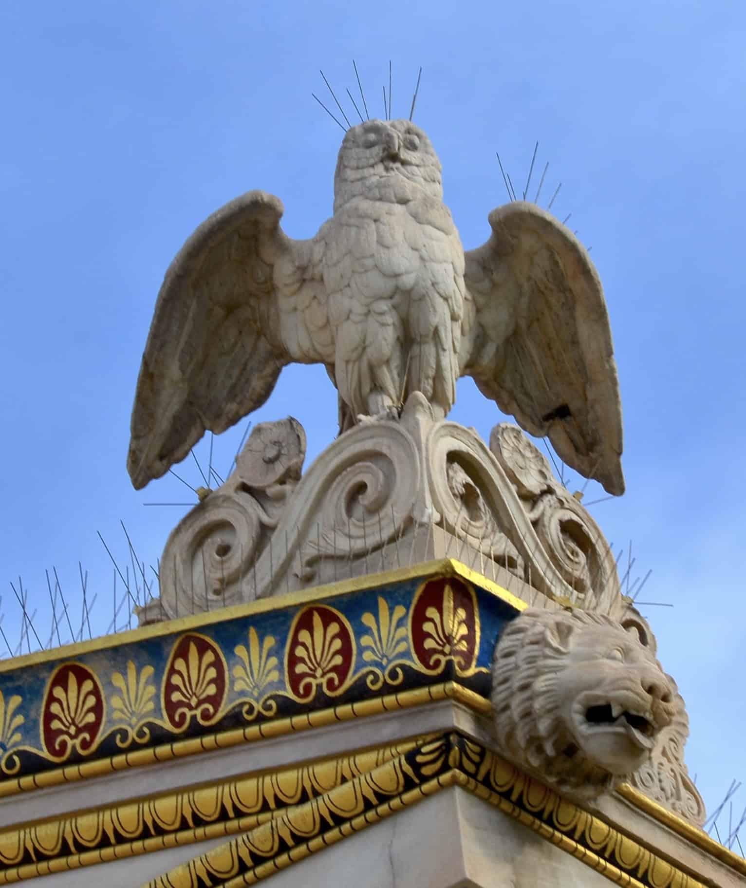 Owl sculpture on the corner and lion head gutter at the Academy of Athens