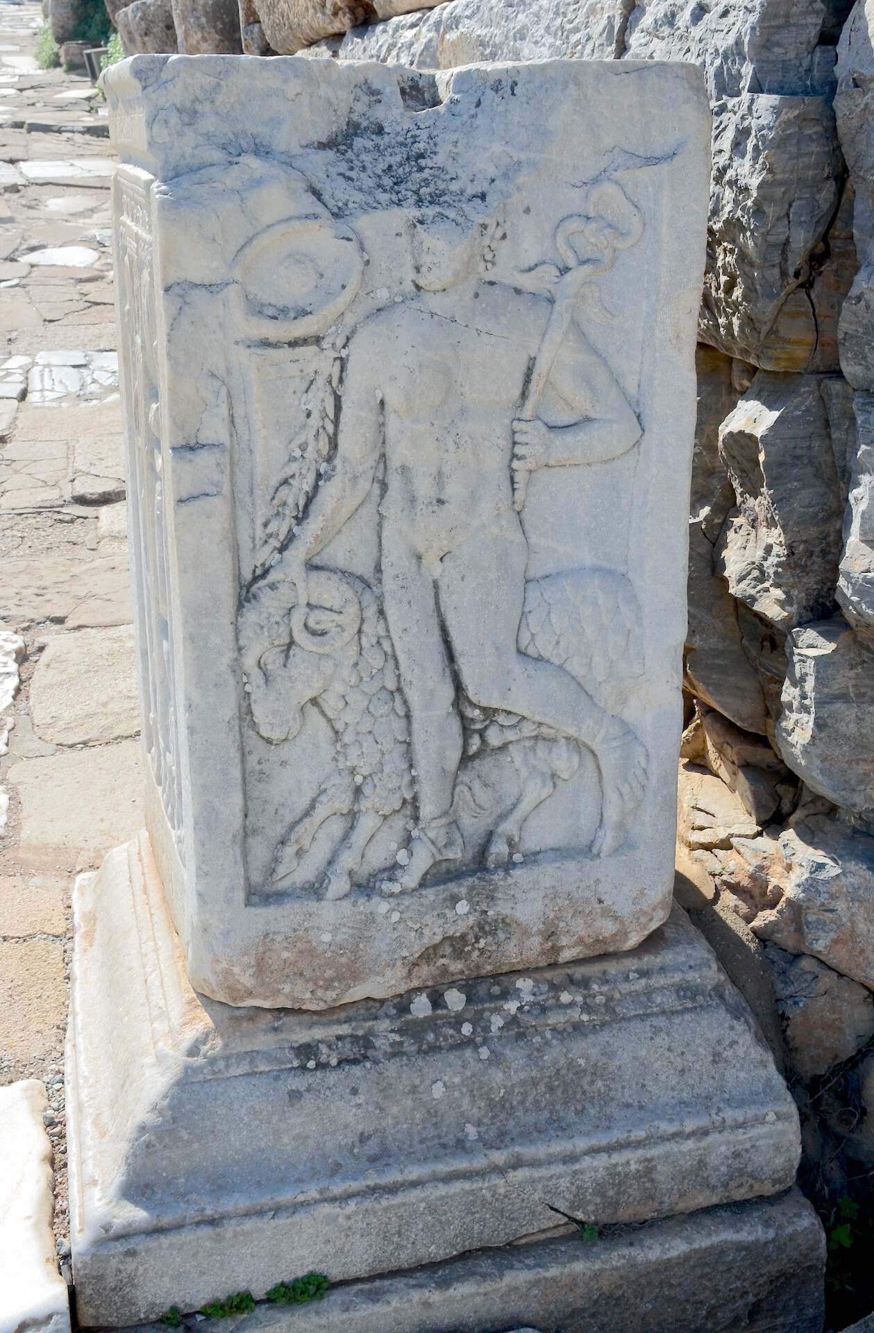 Hermes holding a staff and ram's head on a pillar next to the hospital in Ephesus