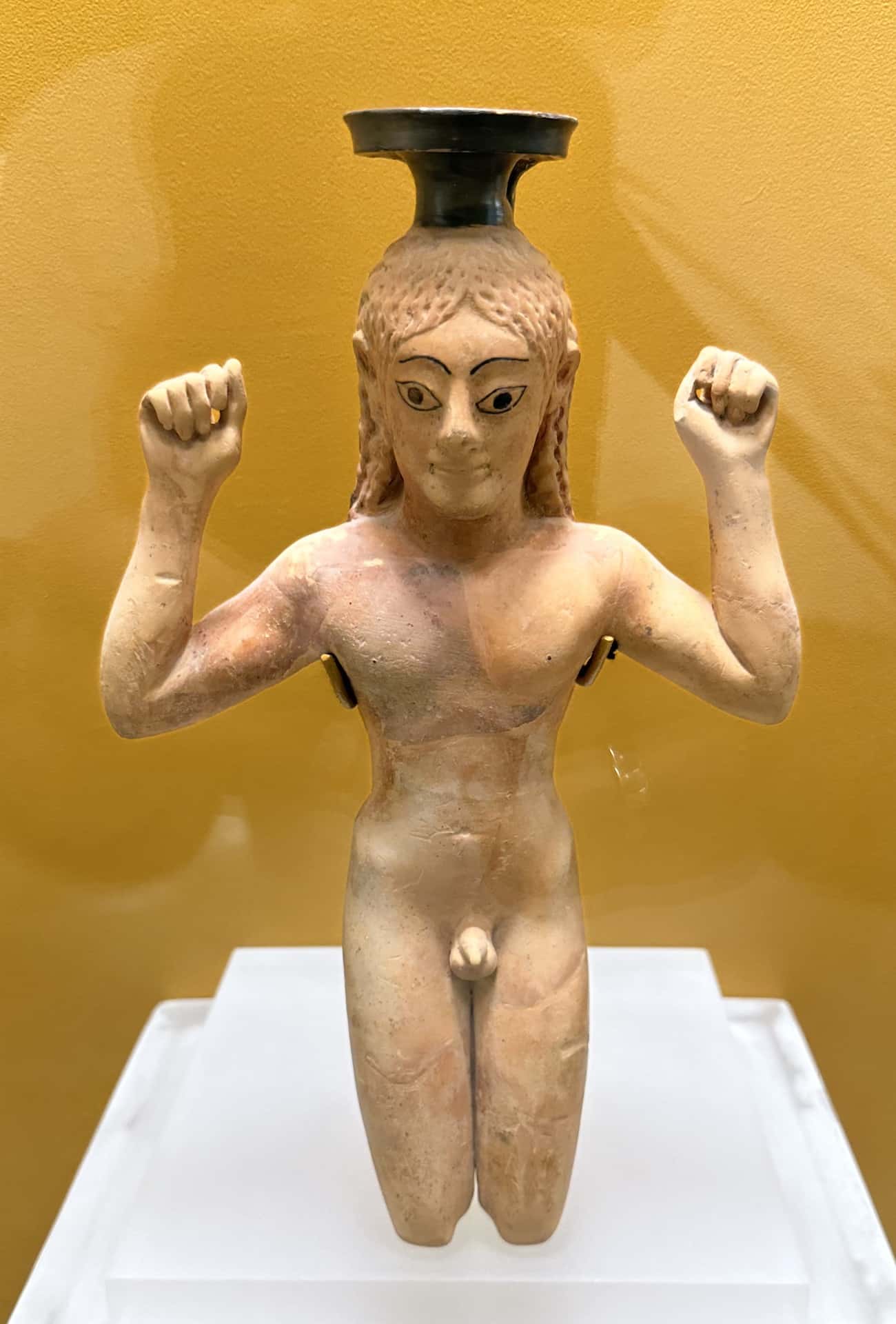 Perfume bottle in the form of a kneeling athlete binding a ribbon about his head as a symbol of victory