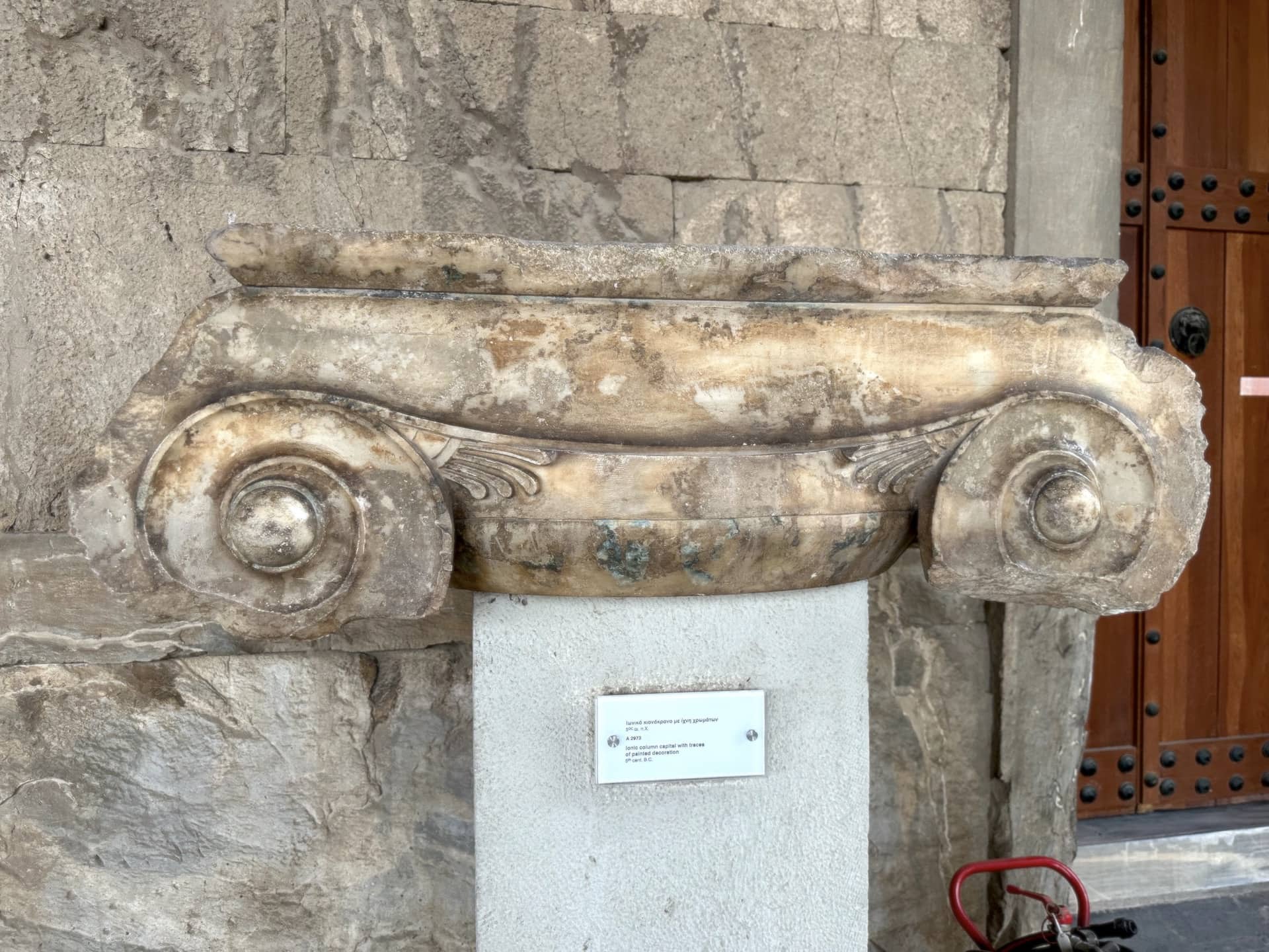 Ionic column capital with traces of painted decoration