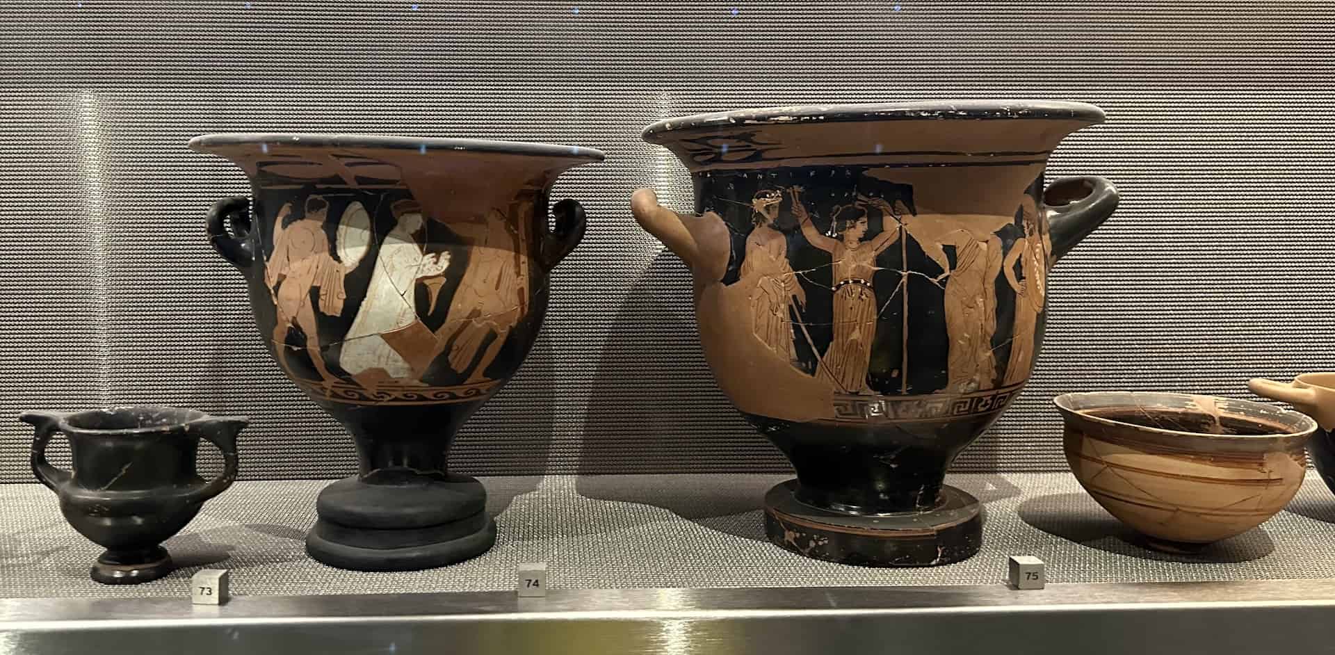 Red-figure krater depicting a religious procession, 350-325 BC (left); Red-figure krater depicting a dancer with castanets, late 5th century BC (right) at the Acropolis Museum in Athens, Greece