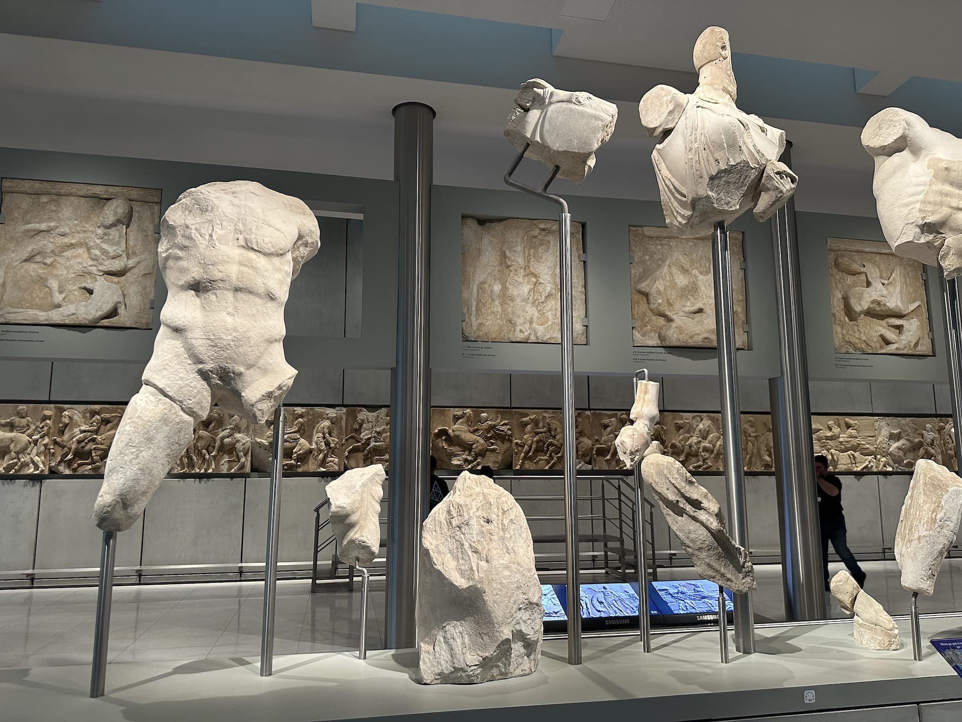 Hermes (left), Athena (center), and Poseidon (right) on the west pediment of the Parthenon at the Acropolis Museum in Athens, Greece