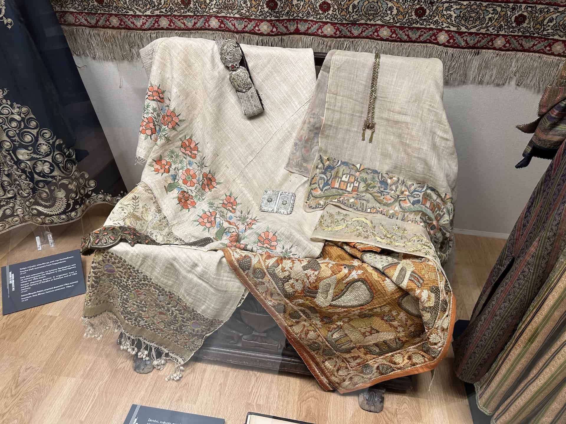 Sheet, wedding towels, tsevres, gold embroidered scarf, and silk covering; belt with buckle from Saframpolis (Safranbolu); belt with buckle; silver buckle; jewelry with a butterfly