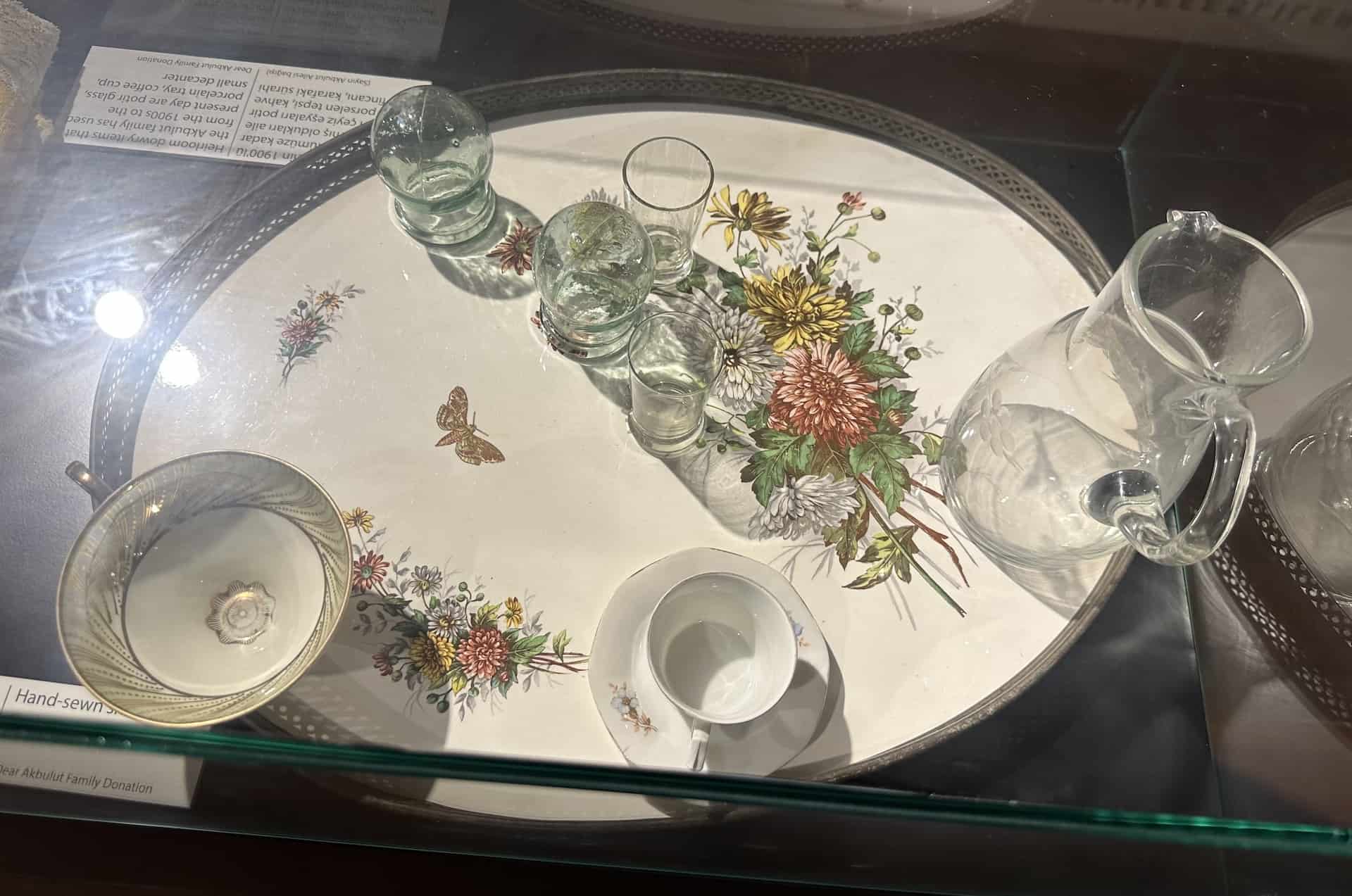 Glasses, coffee cups, and a decanter on a porcelain tray; early 20th century; donated by the Akbulut family in the immigration section at the Selçuk City Memory Museum