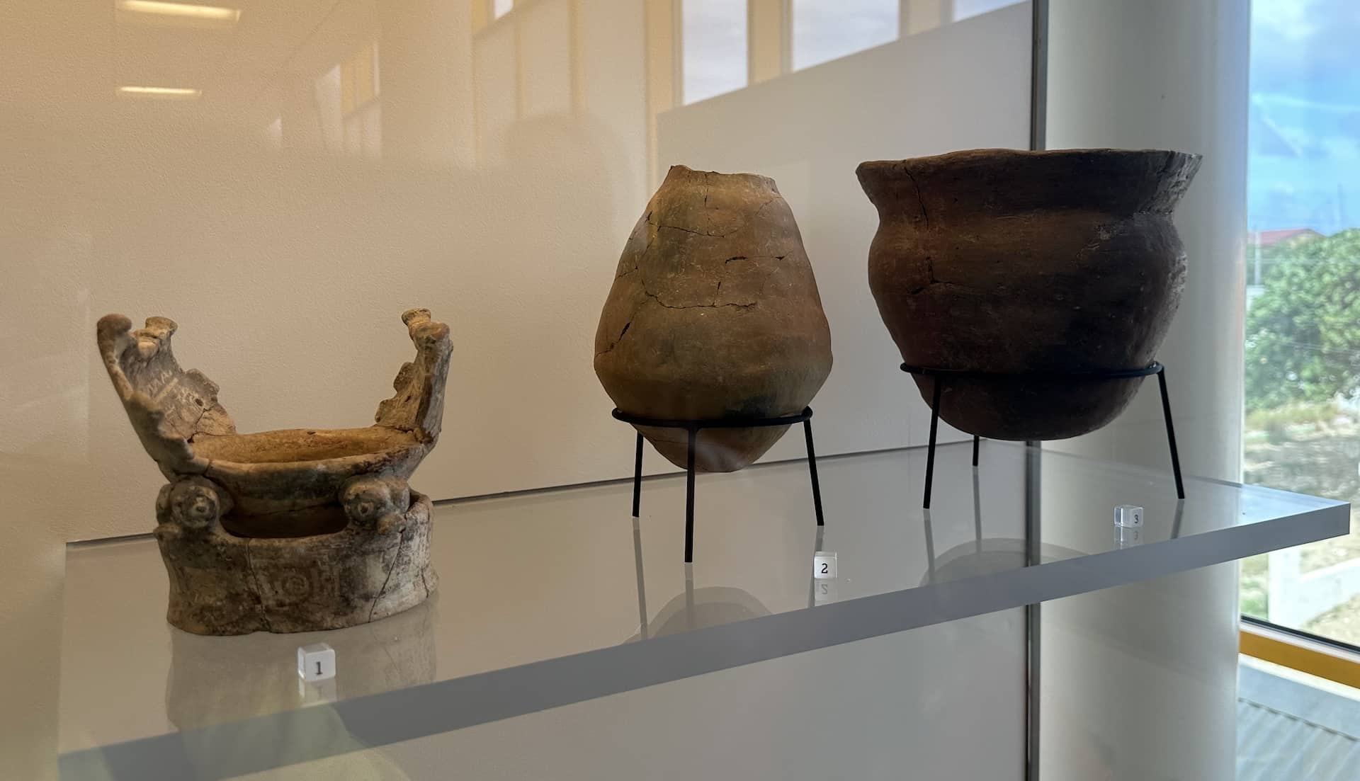 Ceremonial bowl (left) and burial urns (center and right) at the National Archaeological Museum