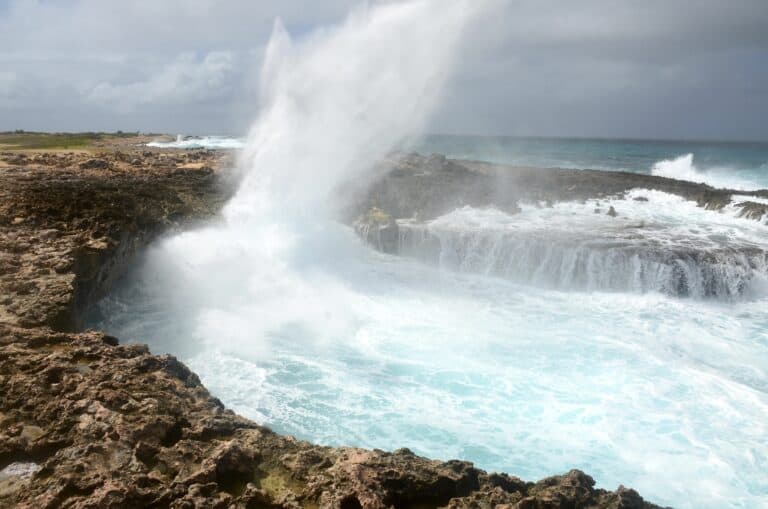 Seawater spraying out of the cave at Westpunt Boca at Noord, Aruba