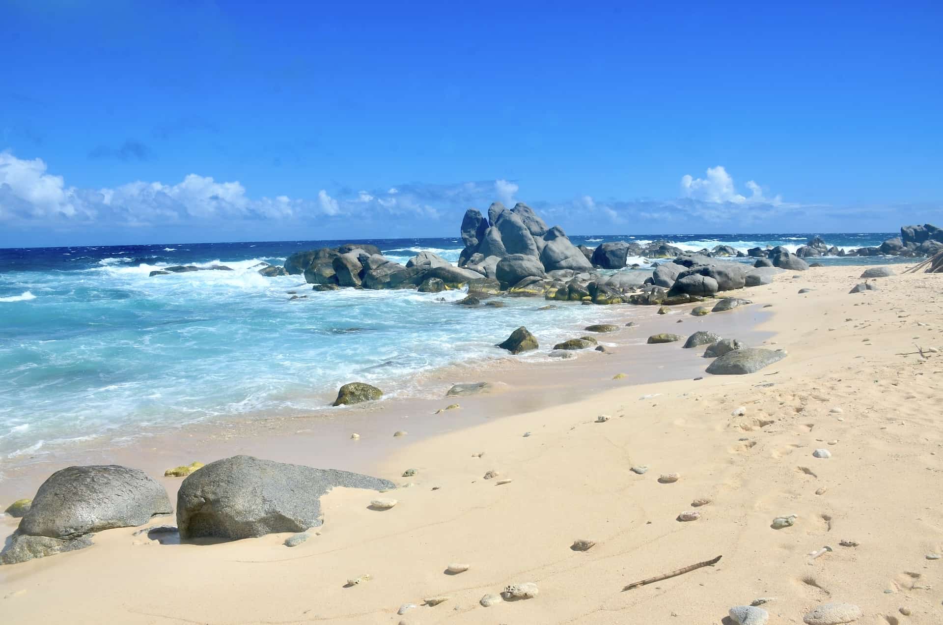 Pink sand and rock formations at Westpunt Beach at Noord, Aruba