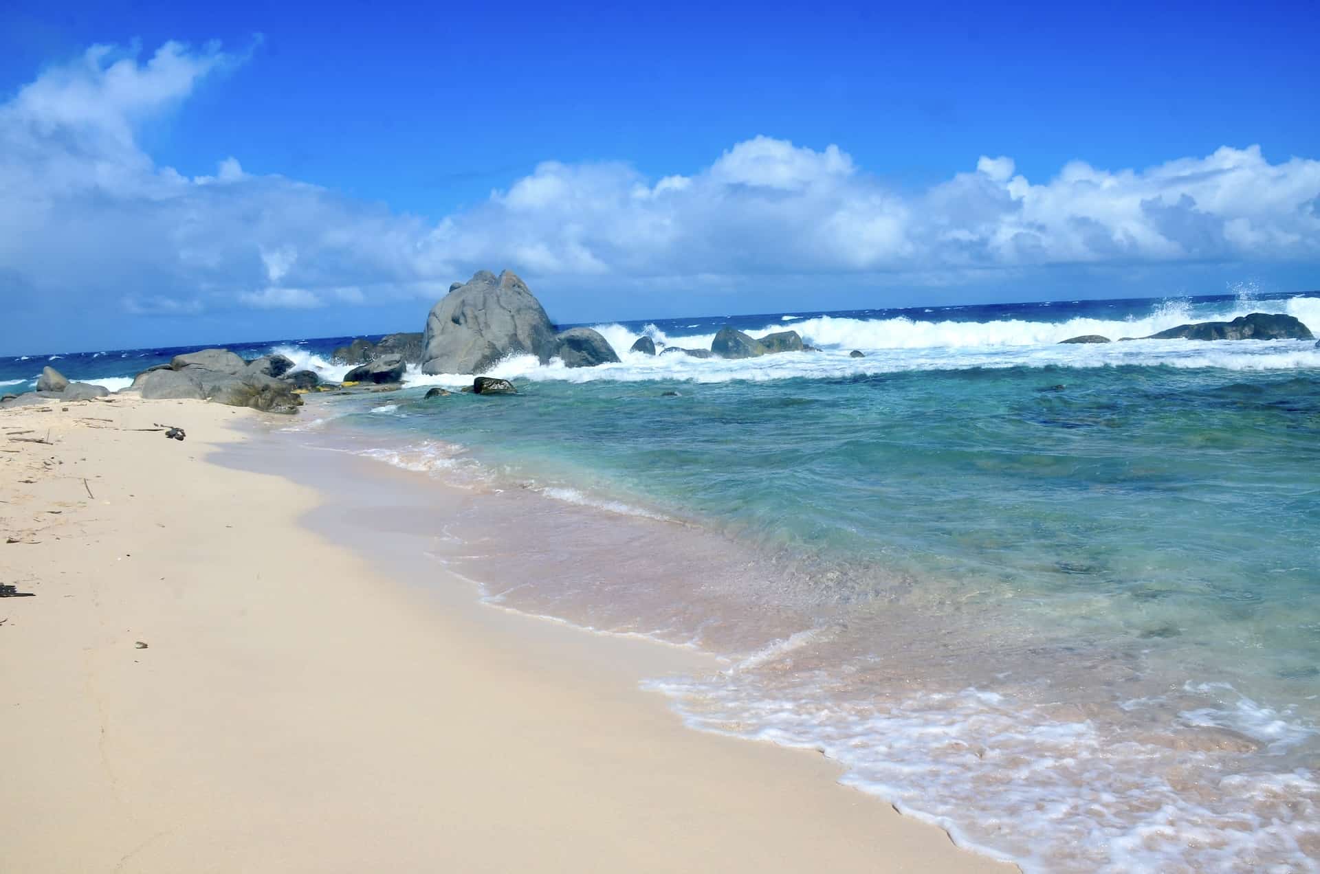 Pink sand and rock formations at Westpunt Beach at Noord, Aruba