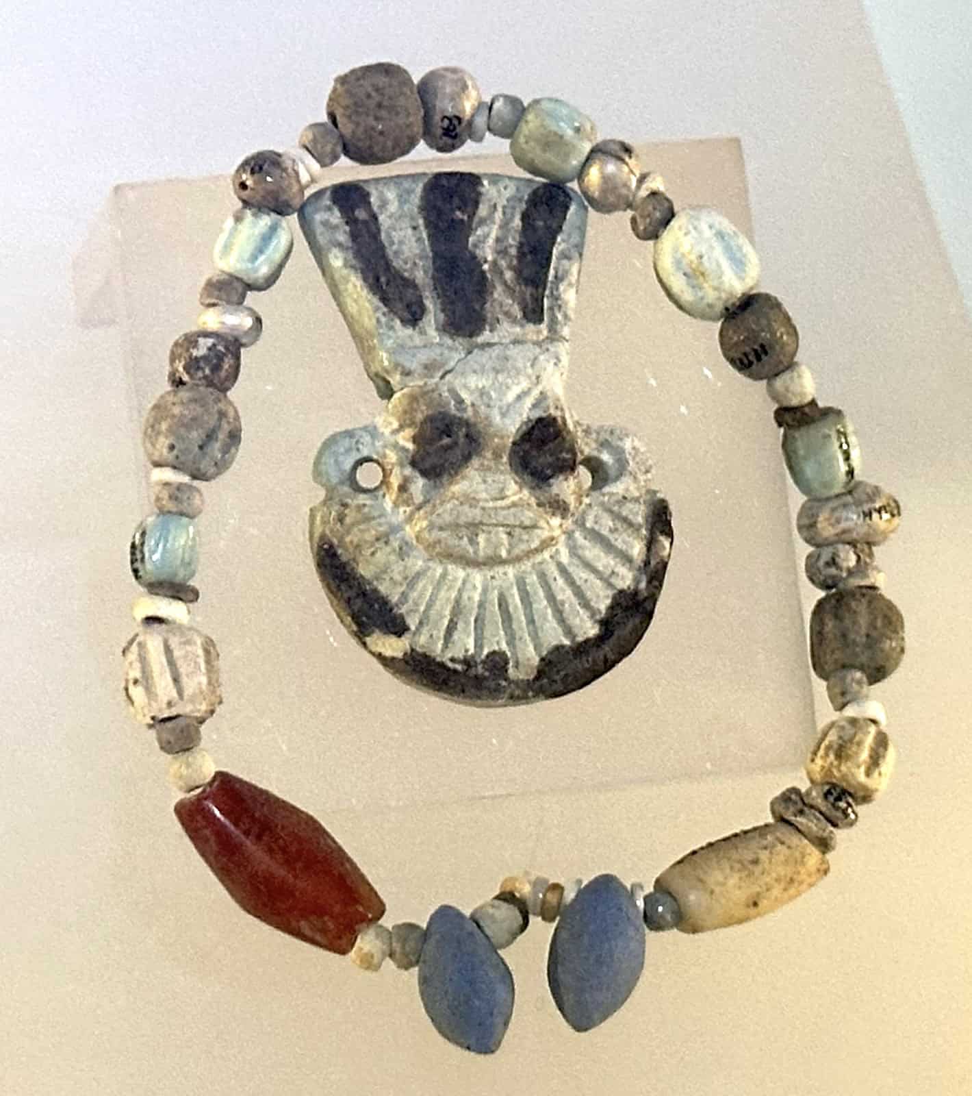 Iron Age necklace depicting the Egyptian god Bes