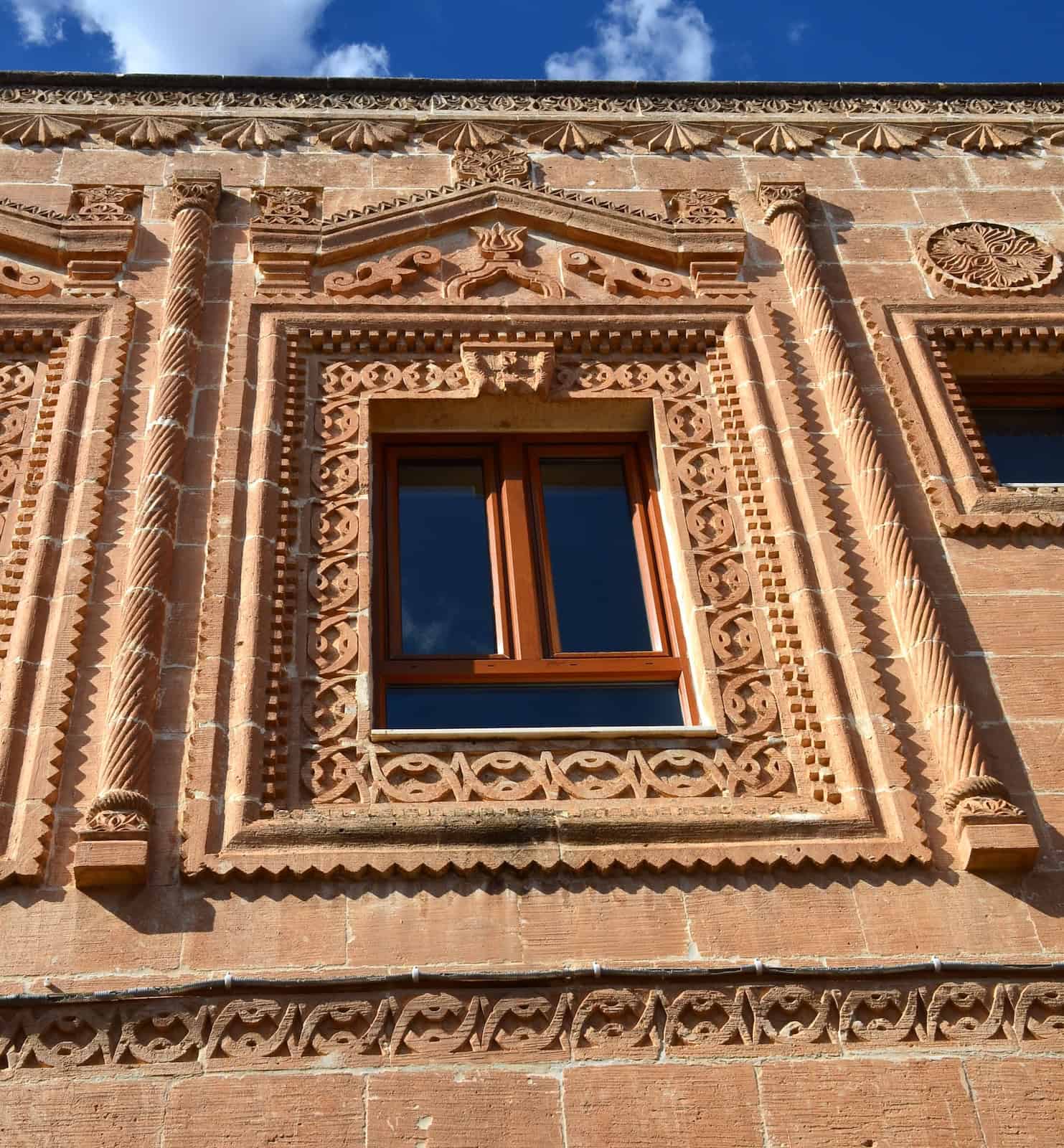 Intricate carvings around a window in Midyat, Turkey